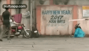 a man is riding a motorcycle next to a sign that says happy new year .
