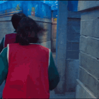 a man wearing a red vest with the number 333 on it is fighting another man