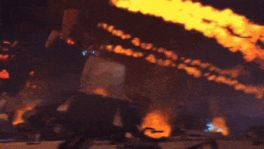 a person is holding a sword in front of a huge fireball ..