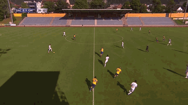 a soccer game is being played and the score is dac 2-1 om
