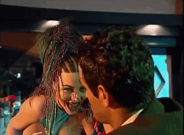 a man and a woman are standing next to each other in a room