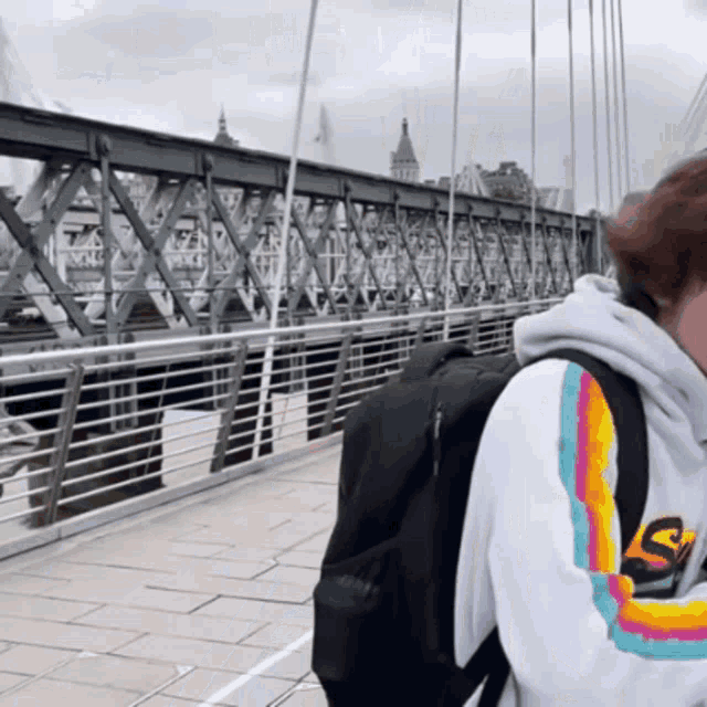 a person wearing a white sweatshirt with the number 9 on the sleeve