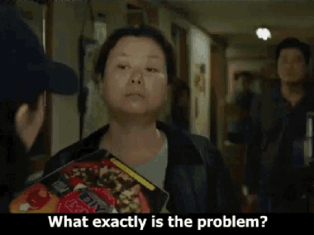 a woman is holding a book and asking what exactly is the problem