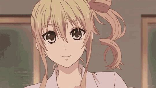 a blonde anime girl with a bow in her hair is smiling .