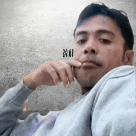 a man with his hand on his chin in front of a wall with the word no written on it