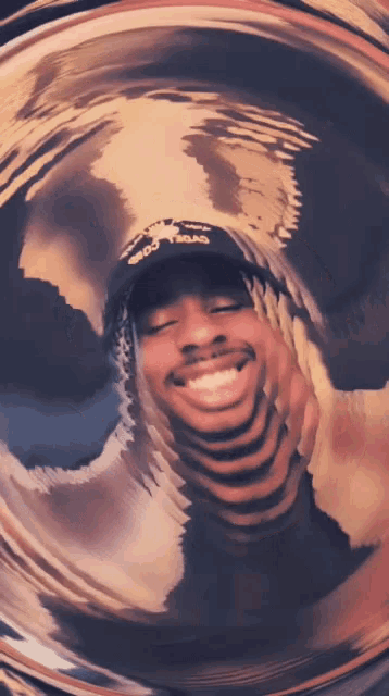 a man wearing a hat with the word cargo on it smiles