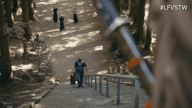 a man is walking up a set of stairs in the woods with the hashtag #lfvstw in the corner