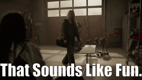 a woman walking in a garage with the words that sounds like fun behind her