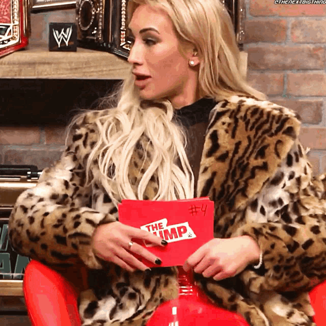 a woman in a leopard print coat is holding a card that says the emp # 4