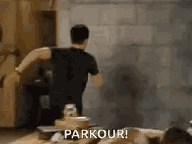 a man is doing a parkour in a room .