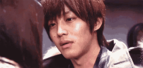 a close up of a young man looking at a woman 's face .