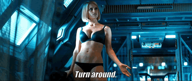 a woman in lingerie is standing in a room with the words turn around behind her