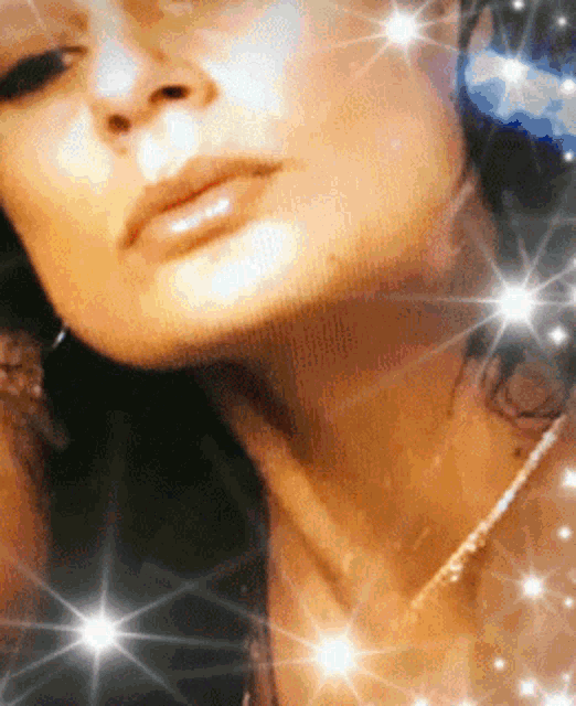 a close up of a woman 's face with a lot of stars around it