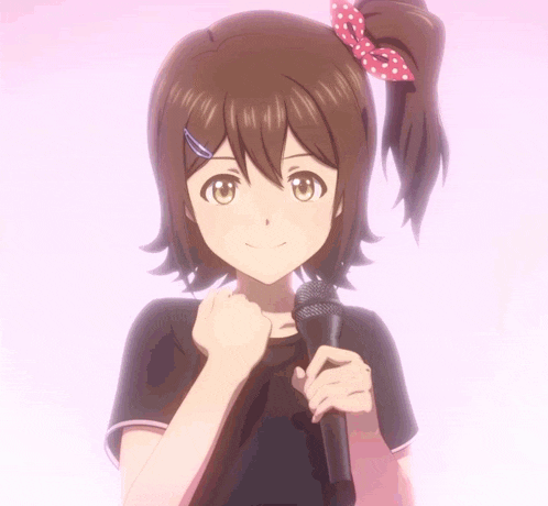 a girl with brown hair is holding a microphone in her hand