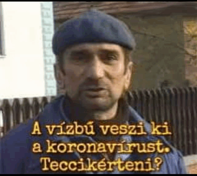 a man wearing a beret and a blue jacket is talking to someone .