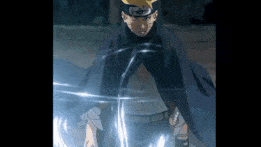 a close up of a person in a cape holding a sword in their hand .