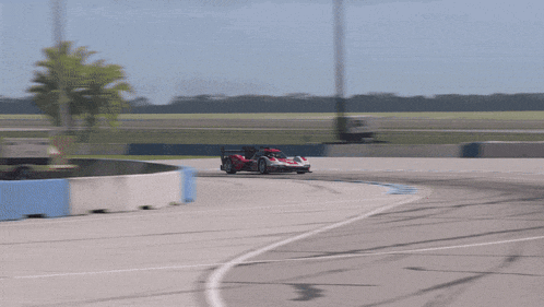 a red and white race car with the number 6 on the side