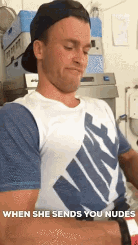 a man wearing a nike shirt is making a face