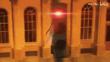 a blurry picture of a building with a red light coming out of the top