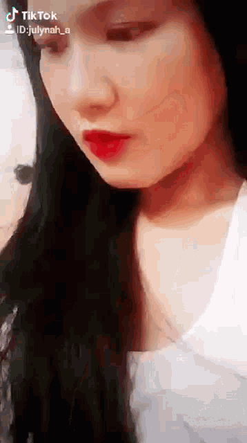 a close up of a woman 's face with a tik tok id