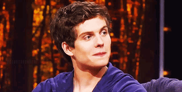a close up of a man 's face with a blurred background that says ' the hunger games '