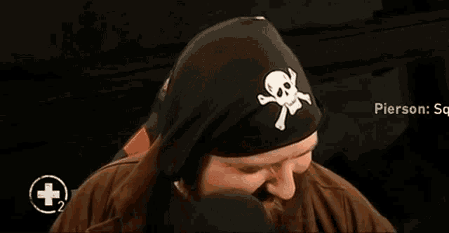 a man with a beard is wearing a pirate hat and a bandana .