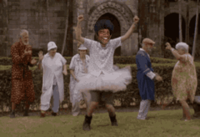 a man in a tutu is dancing with a group of older people