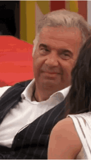 a man is sitting next to a woman and smiling .
