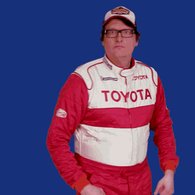 a man wearing a red and white toyota suit