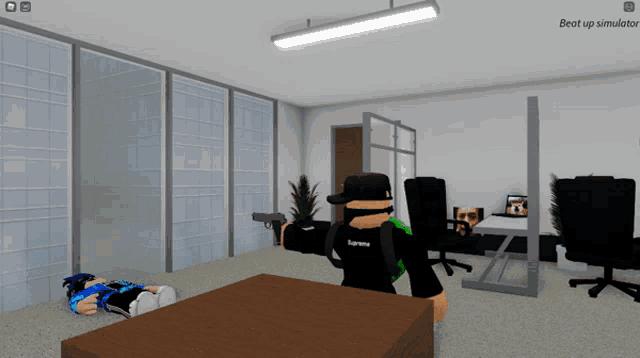 a person in a supreme shirt is holding a gun in a room