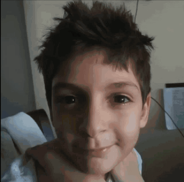 a close up of a child 's face with a serious look on his face