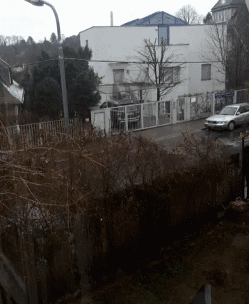 a white car is parked in front of a building that has a sign that says ' polizei ' on it
