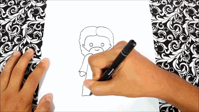 a person is drawing a picture of jesus with a black marker