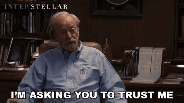a man sitting in a chair with the words i 'm asking you to trust me