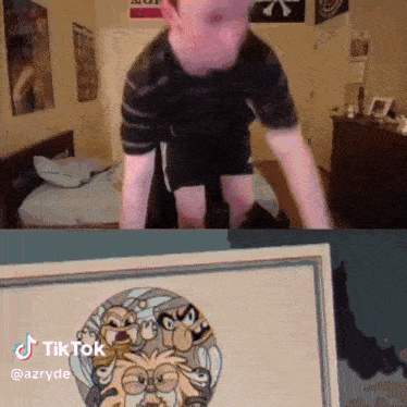 a man is doing push ups in front of a picture of a cartoon character ..