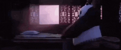 a person is laying on a bed with a purple pillow and a purple blanket .