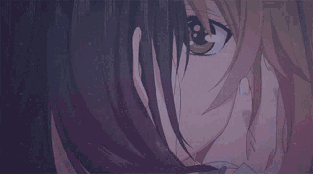 a close up of a woman 's face with a hand on her face