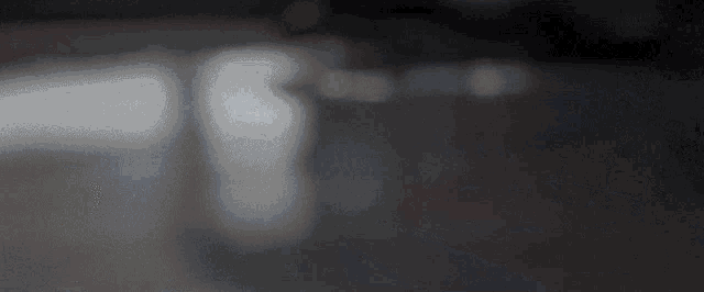 a blurred image of a person 's face with the number 18 in the background