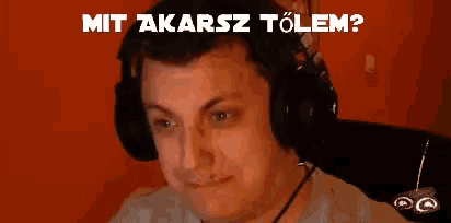 a man wearing headphones with the words " mit akarsz tolem " above him
