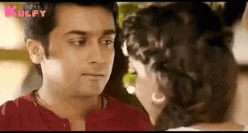 a man and a woman are kissing each other in a movie .