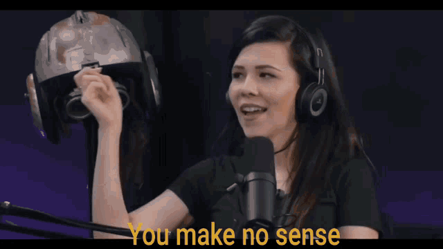 a woman wearing headphones stands in front of a microphone and says " you make no sense " in yellow letters