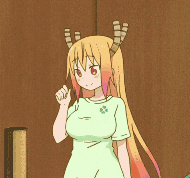 a girl with horns on her head is standing in front of a wall