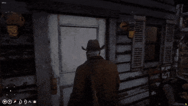 a man in a cowboy hat stands in front of a door in a game