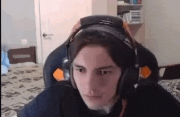a man wearing headphones is sitting in a chair in a bedroom .