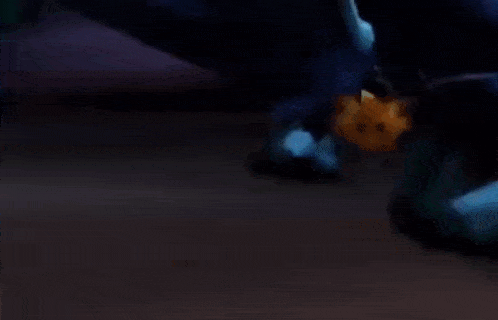 a dragon is laying on the ground with its wings outstretched .