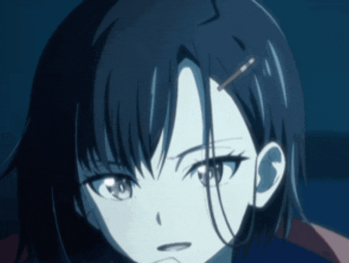a close up of a girl 's face with a hairpin in her hair
