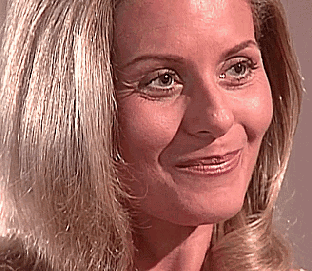 a close up of a woman 's face smiling