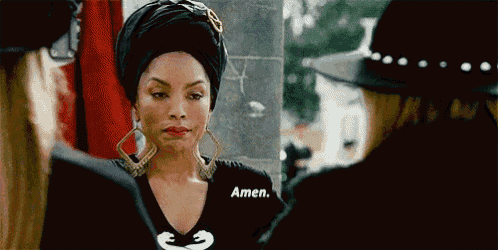 a woman is wearing a black shirt that says amen on it