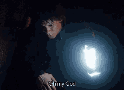 a man is holding a flashlight in his hand in the dark and says oh my god .