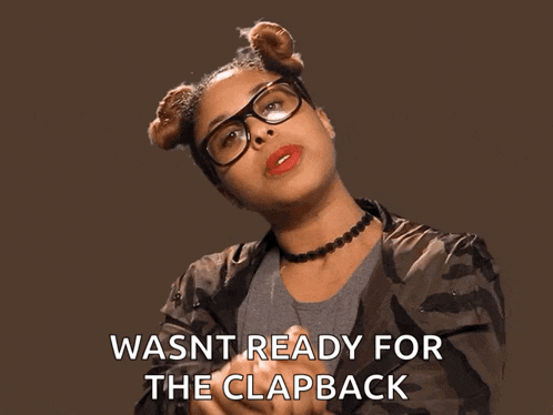 a woman wearing glasses and a choker is saying wasnt ready for the clapback